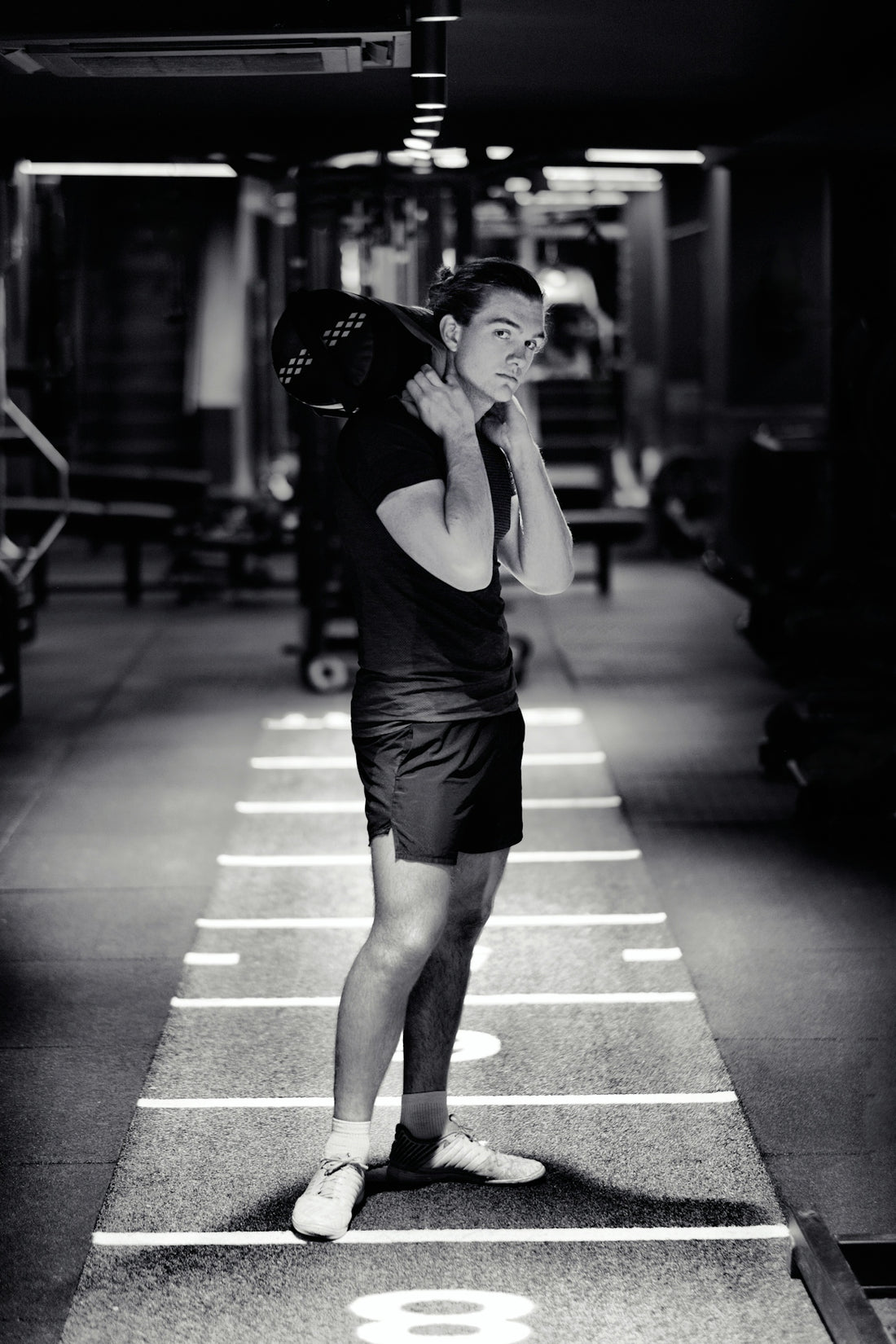 a man standing in a parking garage talking on a cell phone
