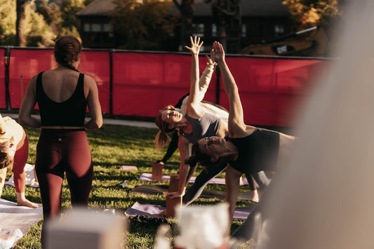 a group of people doing yoga in a park