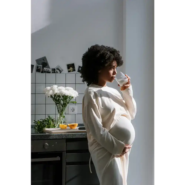 Pregnant woman drinking milk.